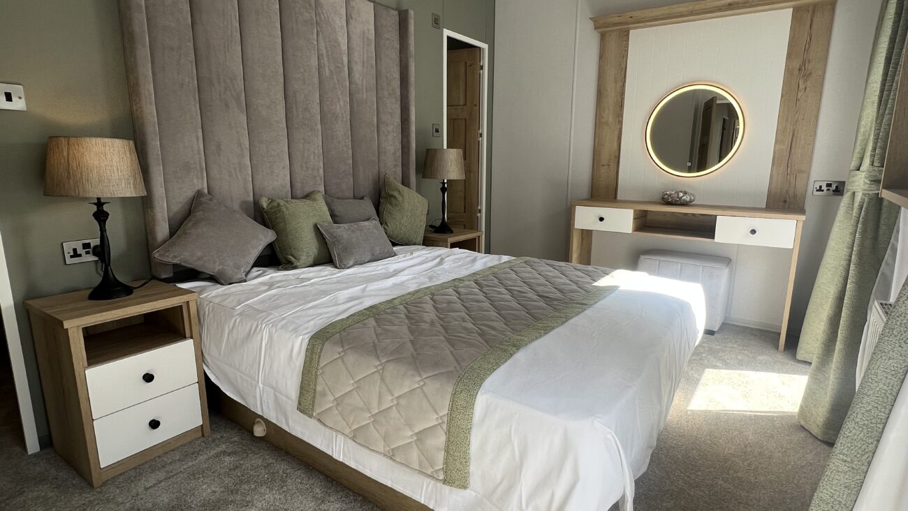 A smart grey and white double bedroom in a Dorchester Static Caravan.