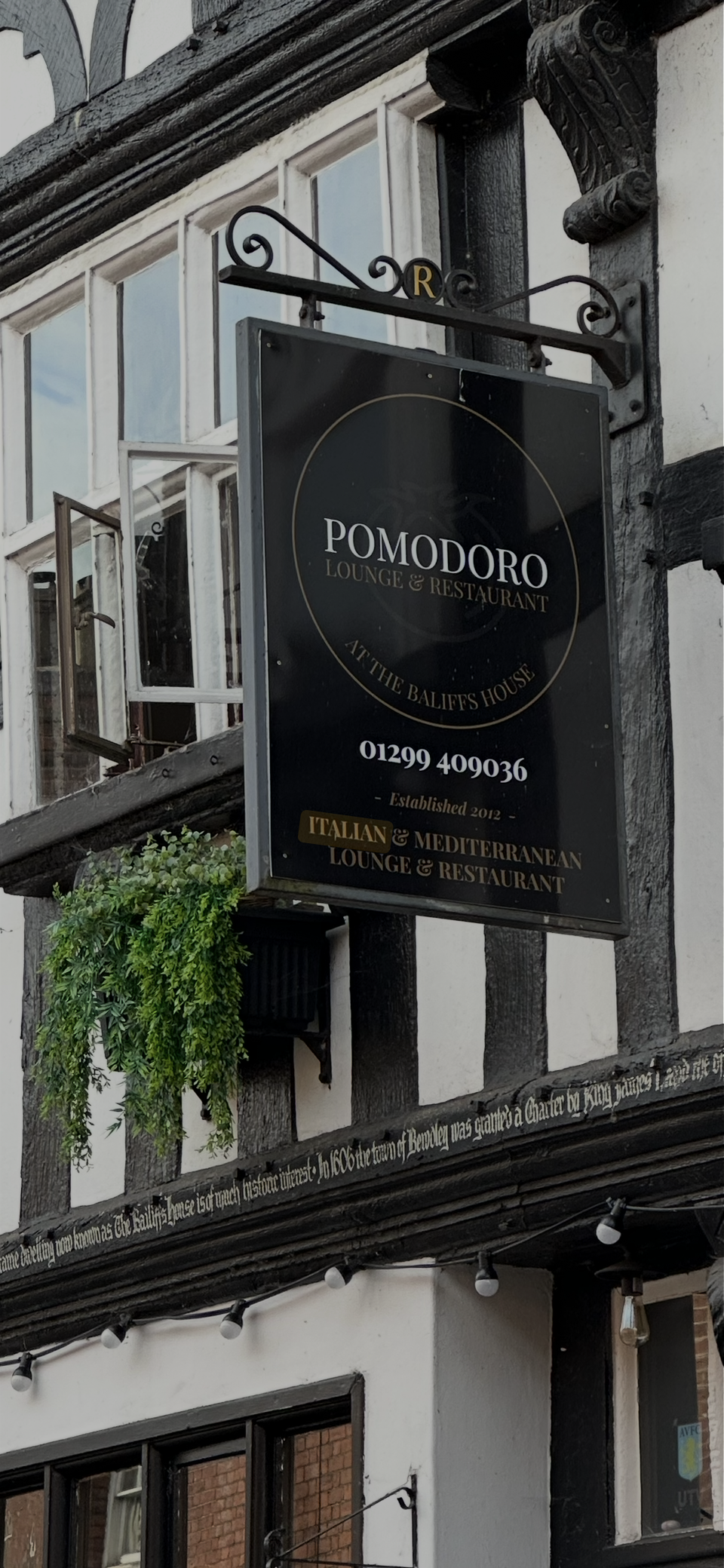A back and white building with Italian restaurant sign