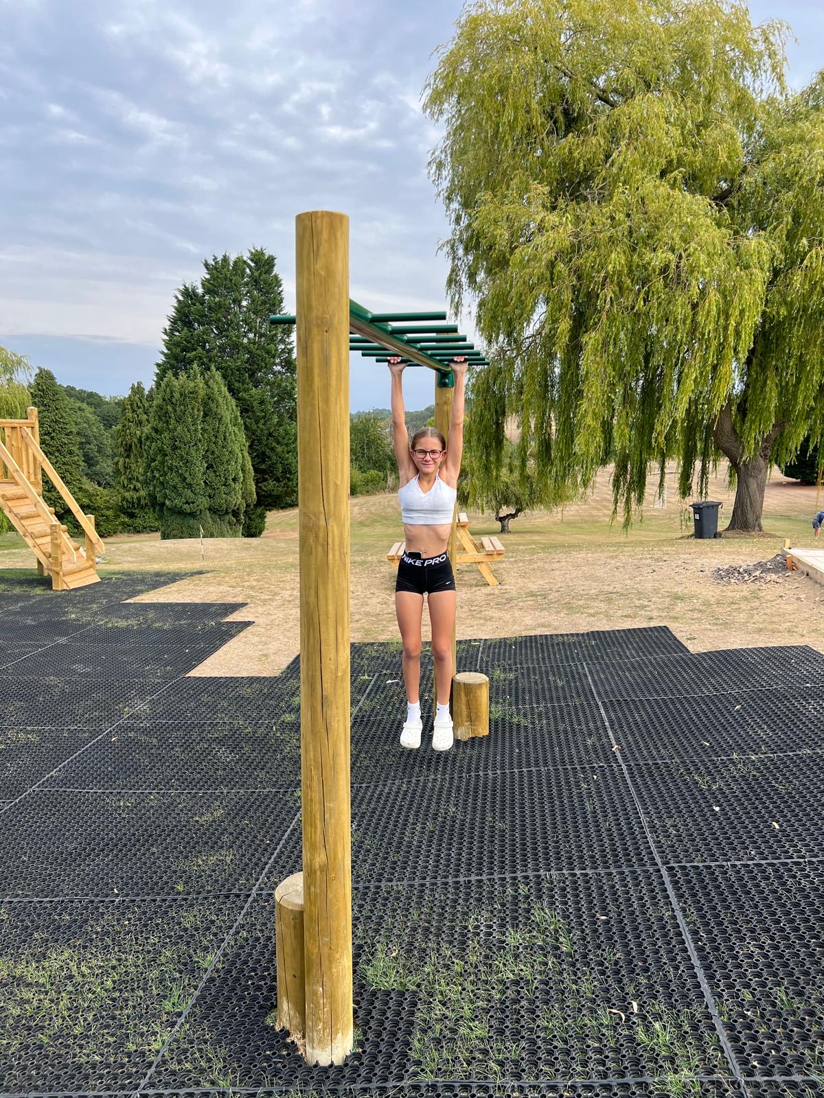 Climbing frame with child hanging