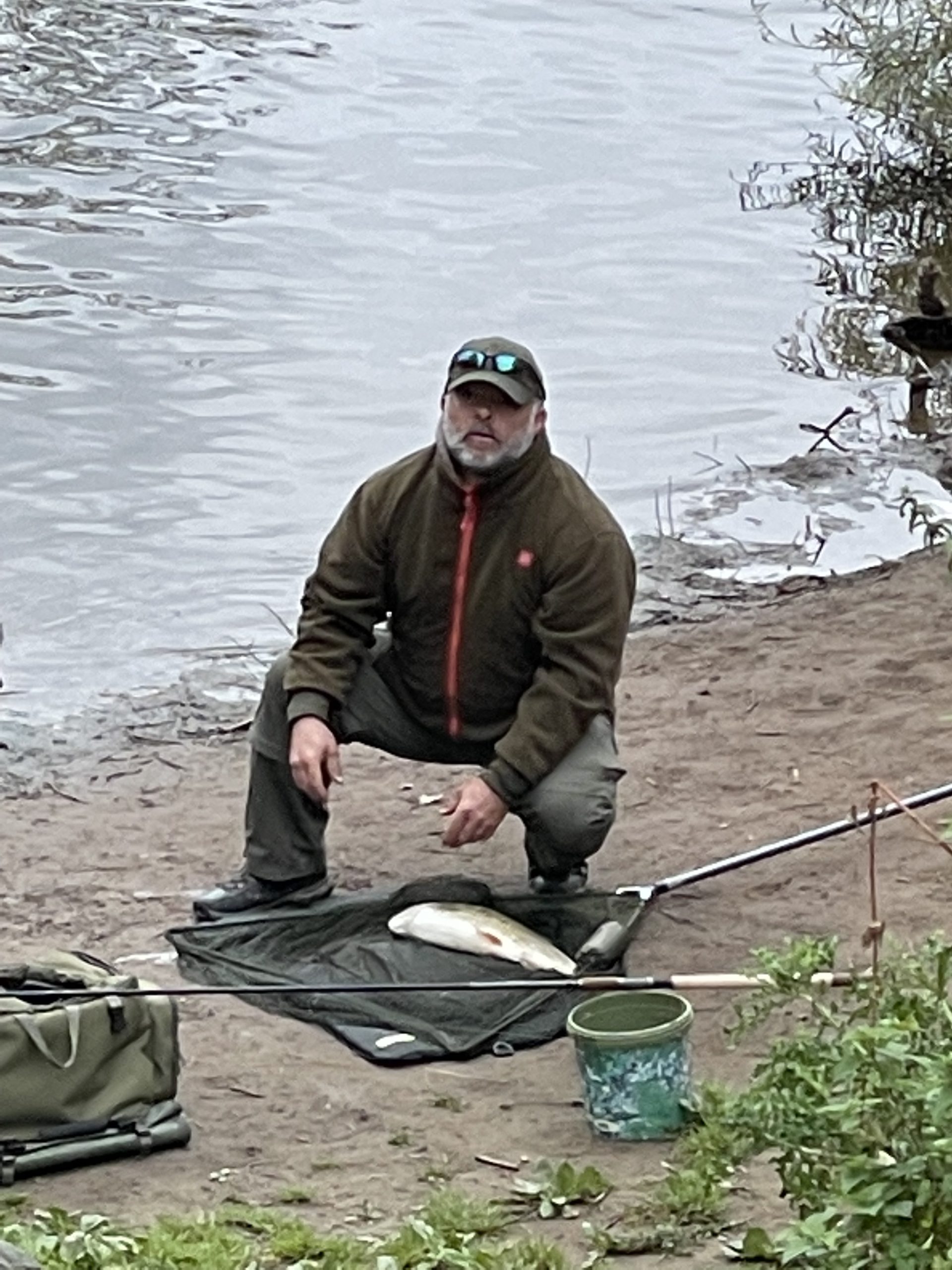 A man catches a fish by the bin for seven
