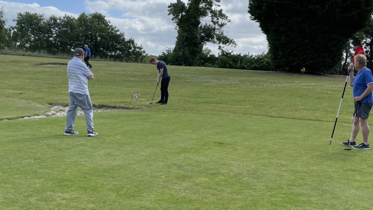 a group playing pitch and putt golf on Bank Farm, holiday parks, golf course