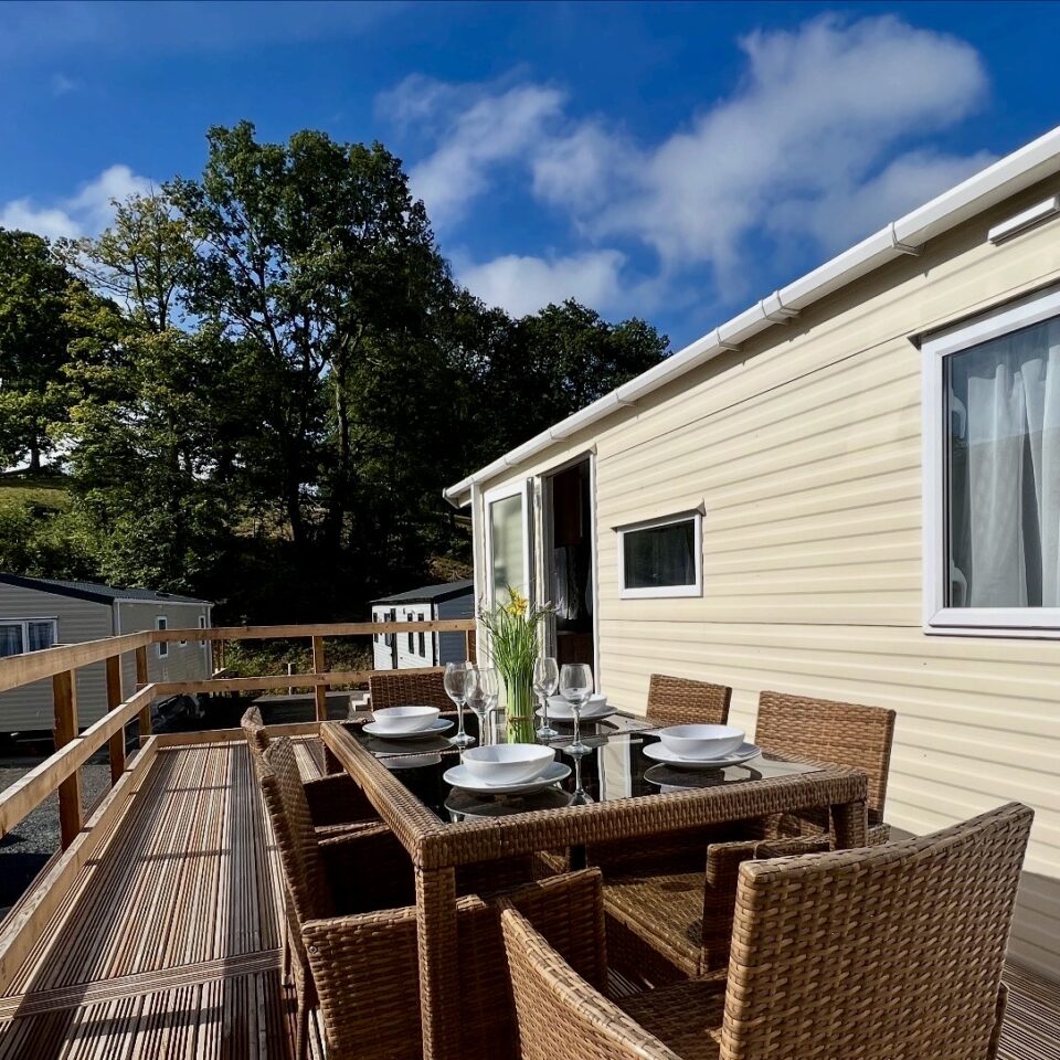 A holiday home with outside table set for dinner