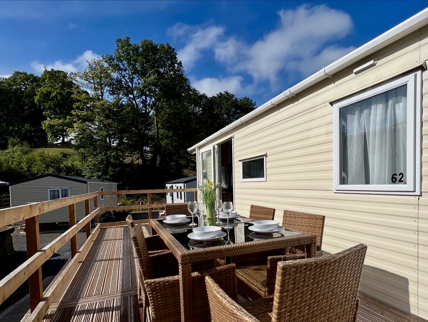 A holiday home with outside table set for dinner